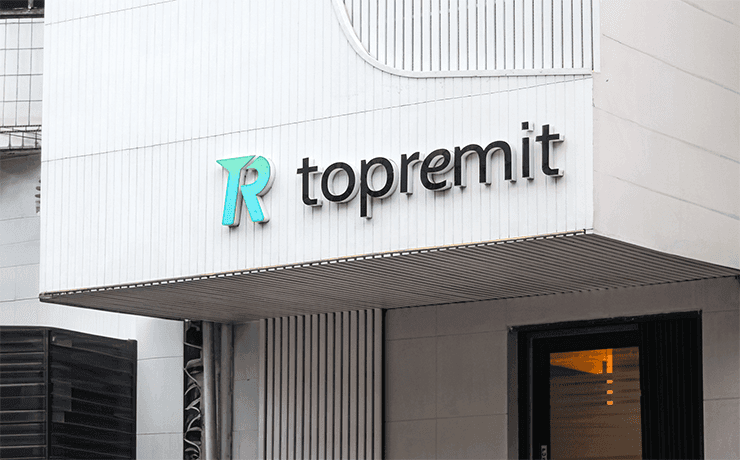 Topremit office from 2023 to the present, featuring a white exterior with the Topremit logo on the front of the building.