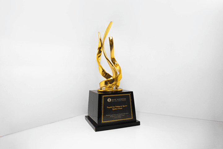 A gold trophy with a black base engraved with “Best Remittance Payment Service Provider” in 2025.